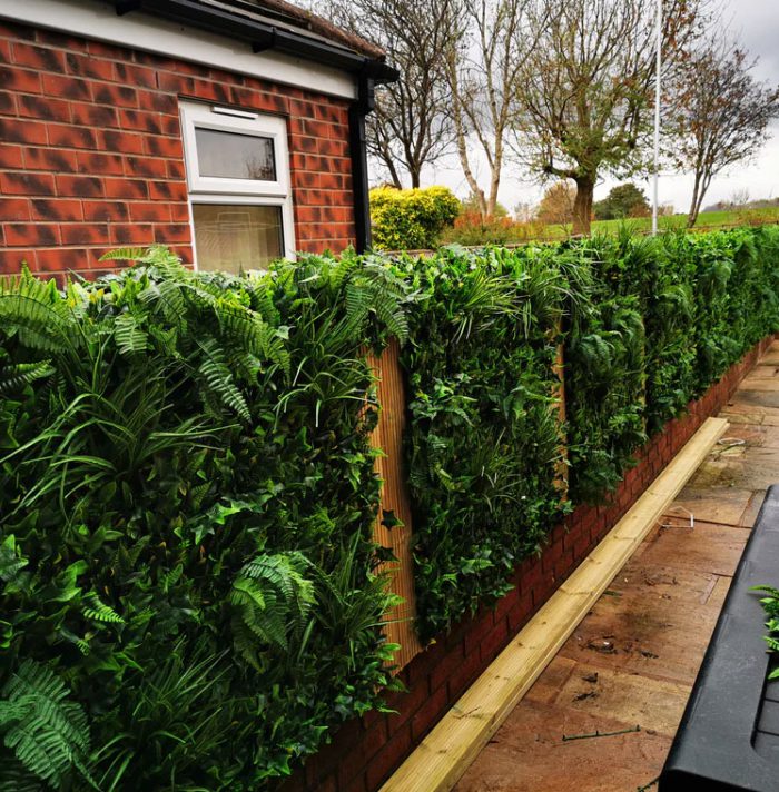 how to attach artificial hedge to brick wall